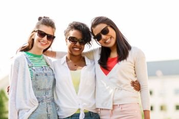 female friendship, summer and eyewear - happy young women in sunglasses outdoors. happy young women in sunglasses outdoors