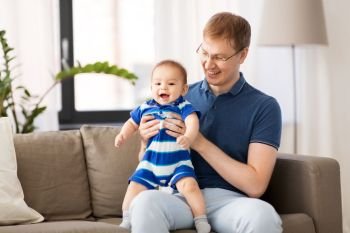 family, fatherhood and people concept - happy father with baby son at home. happy father with baby son at home