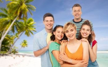 travel, tourism and vacation concept - group of happy smiling friends over tropical beach background in french polynesia. happy friends over tropical beach background