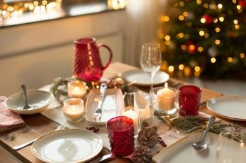 christmas, holidays and eating concept - table served for festive dinner at home. table served for christmas dinner at home