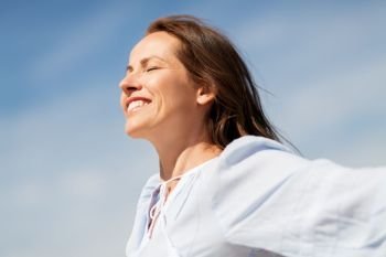 people and leisure concept - happy smiling woman enjoying sun. happy smiling woman enjoying sun