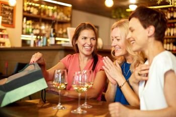people, leisure and lifestyle concept - women with shopping bags at wine bar or restaurant. women with shopping bags at wine bar or restaurant