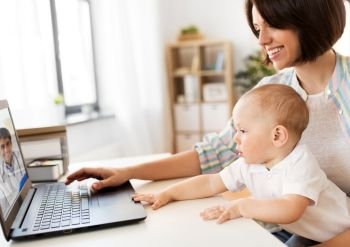 medicine, technology and healthcare concept - happy mother with baby son having video chat with family doctor on laptop computer at home. mother with baby having video chat with doctor