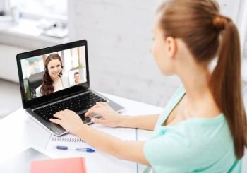 business, education and technology concept - woman or student having video call with customer service operator or teacher on laptop computer at home or office. woman or student having video call on laptop