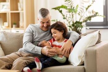 family, fatherhood and people concept - happy father with preteen and baby son at home. happy father with preteen and baby son at home