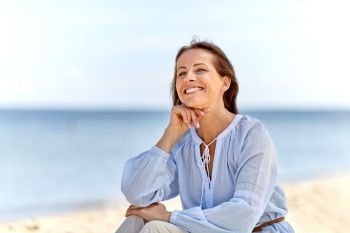 people and leisure concept - happy smiling woman on summer beach. happy smiling woman on summer beach