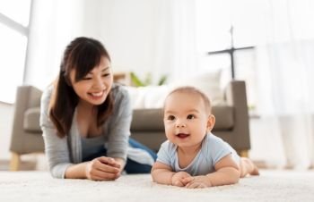 babyhood, childhood and people concept - sweet little asian baby boy and mother at home. sweet little asian baby boy with mother at home