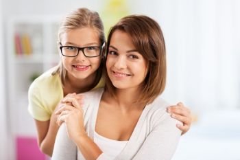 people and family concept - portrait of happy mother and daughter at home. portrait of happy mother and daughter at home
