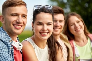 leisure, people and friendship concept - happy teenage friends outdoors in summer. happy teenage friends outdoors in summer