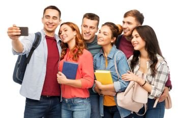 education, high school and technology concept - group of smiling students with books taking selfie by smartphone over white background. group of students taking selfie by smartphone