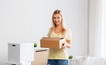 moving, people and real estate concept - happy woman with boxes at new home. happy woman with boxes moving to new home