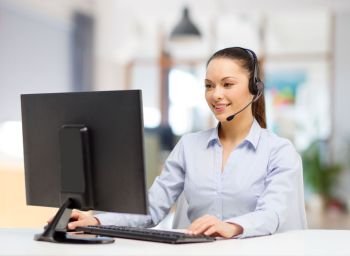 business, technology and communication concept - female helpline operator in headset working at office. helpline operator in headset working at office