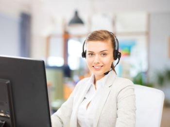 business, technology and communication concept - female helpline operator in headset working at office. helpline operator in headset working at office