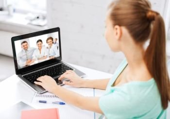business, education and technology concept - woman or student having video interview with employer or teacher team on laptop computer at home or office. woman or student having video interview on laptop