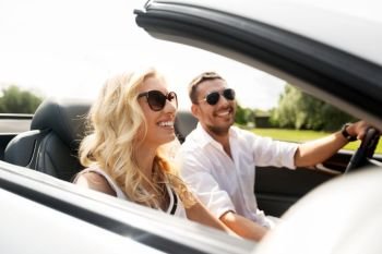 leisure, road trip, dating, couple and people concept - happy man and woman driving in cabriolet car outdoors. happy man and woman driving in cabriolet car