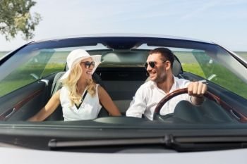 leisure, road trip, dating, couple and people concept - happy man and woman driving in cabriolet car outdoors. happy man and woman driving in cabriolet car