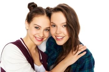 people and friendship concept - happy smiling pretty teenage girls hugging over white background. happy smiling pretty teenage girls hugging