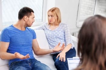 people, relationship difficulties and family therapy concept - couple with problem at psychologist office. couple with problem at family psychologist office