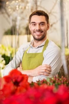 sale, small business and floristry concept - happy smiling florist man or seller at flower shop. florist man or seller at flower shop counter