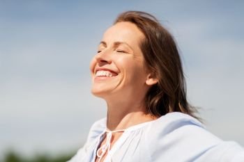people and leisure concept - happy smiling woman enjoying sun. happy smiling woman enjoying sun