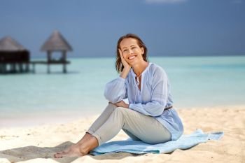 travel, tourism and summer vacation concept - happy smiling woman over exotic tropical beach and bungalow shed background. happy woman over tropical beach and bungalow