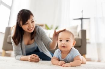 babyhood, childhood and people concept - sweet little asian baby boy and mother at home. sweet little asian baby boy with mother at home