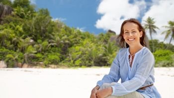 people and summer concept - happy smiling woman over seychelles island tropical beach background. happy woman over seychelles island tropical beach