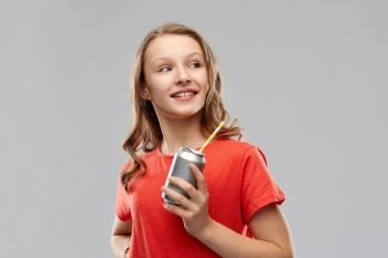 drinks and people concept - teenage girl in red t-shirt holding can of soda with paper straw over grey background. teenage girl holding can of soda with paper straw