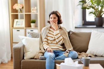 cold and health problem concept - sick woman in blanket coughing at home. sick woman in blanket coughing at home