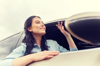 summer vacation, holidays, travel, road trip and people concept - happy young woman driving in car. happy young woman driving in car