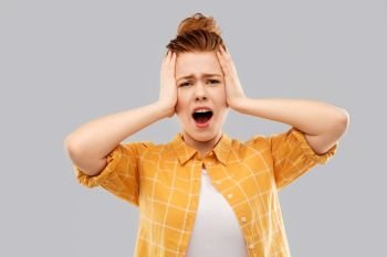 stress, failure and people concept - terrified red haired teenage girl in checkered shirt screaming over grey background. terrified red haired teenage girl screaming