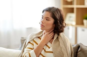 cold and health problem concept - unhappy sick woman with sore throat at home. unhappy sick woman with sore throat at home