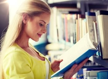 education, high school, university, learning and people concept - smiling student girl reading book at library. high school student girl reading book at library