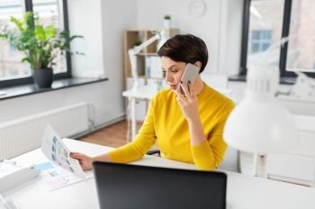 business, technology and ui design concept - creative woman with user interface templates calling on smartphone at office. ui designer calling on smartphone at office