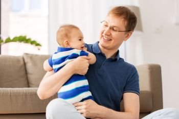 mixed-race family, fatherhood and childhood concept - happy father with baby son at home. happy father with baby son at home