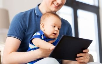 mixed-race family, parenthood and people concept - happy father and little baby son with tablet pc computer at home. happy father and baby son with tablet pc at home