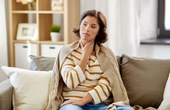 cold and health problem concept - unhappy sick woman with sore throat at home. unhappy sick woman with sore throat at home