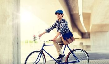 people, style, leisure and lifestyle - smiling hipster man with shoulder bag riding fixed gear bike on city street. happy hipster man with bag riding fixed gear bike