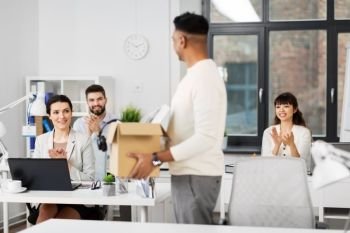 business, new job and quit concept - happy smiling office workers applauding for indian male colleague with box of personal stuff. office workers applauding to male colleague