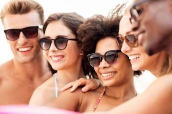 friendship, summer holidays and people concept - close up of happy smiling friends in sunglasses. close up of happy friends in sunglasses in summer