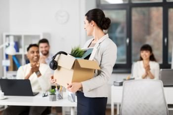business, job and quit concept - female office worker with box of personal stuff and happy smiling colleagues applauding. happy female office worker with personal stuff