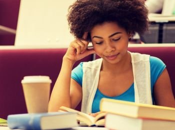 education, high school, university, learning and people concept - bored african student girl with books and coffee on lecture. student girl with books and coffee on lecture