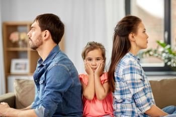 family problem, divorce and people concept - unhappy father, mother and sad little daughter at home. unhappy family at home