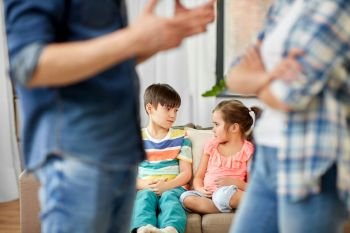 family problem, conflict and people concept - sad children watching their parents quarreling at home. children watching their parents quarreling at home