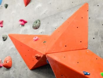 fitness, extreme sport, bouldering, people and healthy lifestyle concept - exercise wall at indoor climbing gym. exercise wall at indoor climbing gym
