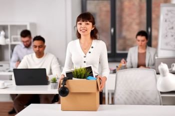 business, new job and corporate concept - happy smiling asian businesswoman or female employee with her personal stuff at office. female employee with personal stuff at office