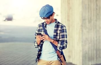 leisure, technology, communication and people concept - hipster man texting message on smartphone. hipster man texting message on smartphone