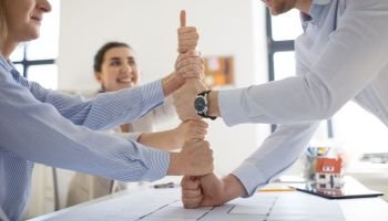 business, gesture and teamwork concept - close up of businesspeople or architects making thumbs up. group of business team making thumbs up gesture