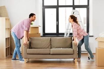 accommodation, repair and real estate concept - happy couple moving sofa at new home. happy couple moving sofa at new home