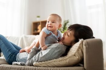 family and motherhood concept - happy young asian mother with little baby son at home. happy mother with little baby son at home